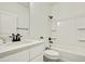 Clean bathroom with white fixtures and a shower/tub combo at 12326 Deep Creek Dr, Spring Hill, FL 34609