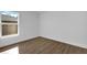 Spacious bedroom with wood-look flooring and large window at 13390 Banyan Rd, Spring Hill, FL 34609