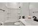 White bathroom with bathtub, shower, and modern fixtures at 14038 Cooper Rd, Spring Hill, FL 34609