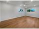 Bright bedroom featuring light wood flooring and large windows at 6015 Olive Ave, Sarasota, FL 34231