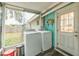 Laundry room with washer, dryer, and backyard access at 4536 Brooksdale Dr, Sarasota, FL 34232