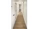 Long hallway with light walls and wood flooring at 8973 85Th St, Seminole, FL 33777