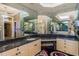 Primary bath with double vanity, granite counters, and mirrored walls at 5900 98Th N Ave, Pinellas Park, FL 33782