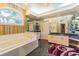 Luxurious bathroom with a large soaking tub, granite vanity, and walk-in shower at 5900 98Th N Ave, Pinellas Park, FL 33782