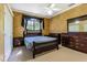 Bright bedroom featuring a wood bed frame and ample closet space at 5900 98Th N Ave, Pinellas Park, FL 33782