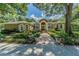 Beautiful home exterior with lush landscaping and a brick walkway at 5900 98Th N Ave, Pinellas Park, FL 33782