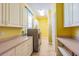 Bright laundry room with ample cabinet space and modern washer and dryer at 5900 98Th N Ave, Pinellas Park, FL 33782