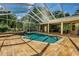 Relaxing pool area with a screened enclosure and stone patio at 5900 98Th N Ave, Pinellas Park, FL 33782