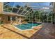 Resort-style pool and screened patio with a waterfall feature at 5900 98Th N Ave, Pinellas Park, FL 33782
