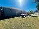 Spacious backyard with a wooden deck and grassy area at 6336 Florida Cir, Apollo Beach, FL 33572