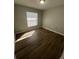 Well-lit bedroom with wood-look floors at 6336 Florida Cir, Apollo Beach, FL 33572