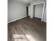Spacious bedroom with wood-look floors and a large closet at 6336 Florida Cir, Apollo Beach, FL 33572