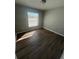Sunny bedroom with wood-look floors and window coverings at 6336 Florida Cir, Apollo Beach, FL 33572