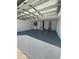 Bright and clean garage with new epoxy flooring and overhead storage at 6336 Florida Cir, Apollo Beach, FL 33572