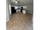 Modern kitchen with white cabinets, granite counters, and tile floor at 6336 Florida Cir, Apollo Beach, FL 33572