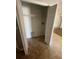 Laundry closet with built-in shelving and tile floor at 6336 Florida Cir, Apollo Beach, FL 33572