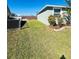 Side yard with grassy area and chain link fence at 6336 Florida Cir, Apollo Beach, FL 33572