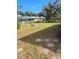 Sprawling backyard with mature trees and fire pit at 21300 Washburn Ave, Port Charlotte, FL 33952