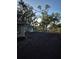 View of home's backyard featuring newly laid dirt and trees at 21300 Washburn Ave, Port Charlotte, FL 33952