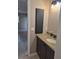 Updated bathroom featuring a granite vanity and wall mounted cabinet at 21300 Washburn Ave, Port Charlotte, FL 33952