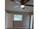 Bright bedroom featuring a ceiling fan, a window, and wood-look floors at 21300 Washburn Ave, Port Charlotte, FL 33952
