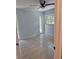Bright bedroom featuring a ceiling fan, tiled flooring, and natural light from the windows at 21300 Washburn Ave, Port Charlotte, FL 33952