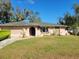 Charming single-story home with a well-manicured front lawn and a driveway at 21300 Washburn Ave, Port Charlotte, FL 33952