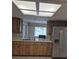Kitchen featuring wood cabinets, stainless steel refrigerator, and laminate countertops at 21300 Washburn Ave, Port Charlotte, FL 33952