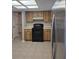 Functional kitchen features neutral tile floors and cabinetry with essential appliances at 21300 Washburn Ave, Port Charlotte, FL 33952