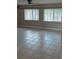 Living room showcasing tile flooring, neutral walls, and natural light from windows at 21300 Washburn Ave, Port Charlotte, FL 33952