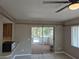 Living room featuring tile flooring, slider doors to a screened in porch, and a ceiling fan at 21300 Washburn Ave, Port Charlotte, FL 33952