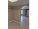 Open-concept living room featuring tile flooring and a welcoming archway at 21300 Washburn Ave, Port Charlotte, FL 33952