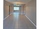 Open living area with tile flooring and recessed lighting, with view to the window in the adjacent room at 21300 Washburn Ave, Port Charlotte, FL 33952