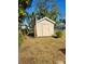 Small storage shed with white trim near the back of the property at 21300 Washburn Ave, Port Charlotte, FL 33952