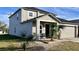 Two-story house with gray siding, porch, and two-car garage at 1057 Brenton Leaf Dr, Ruskin, FL 33570