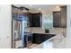 Modern kitchen with stainless steel appliances and dark cabinetry at 6250 Grandview Hill Ct, Bradenton, FL 34203