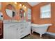 Elegant bathroom with double vanity, soaking tub, and modern fixtures at 4049 Cobia Dr, Hernando Beach, FL 34607