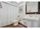 Clean bathroom with pedestal sink, toilet and tiled floor at 4049 Cobia Dr, Hernando Beach, FL 34607
