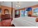 Main bedroom with king-size bed, water views, and private balcony at 4049 Cobia Dr, Hernando Beach, FL 34607