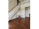 Grand entryway with hardwood floors, staircase, and unique table at 15625 State Road 62 St, Parrish, FL 34219