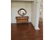 Elegant entryway with wooden buffet, mirror, and hardwood floors at 15625 State Road 62 St, Parrish, FL 34219