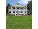 Two story home with white columns and a lush lawn at 15625 State Road 62 St, Parrish, FL 34219
