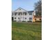 Two-story house with white columns and a lush green lawn at 15625 State Road 62 St, Parrish, FL 34219