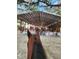 View of an event from behind a horse, showing a large tent at 15625 State Road 62 St, Parrish, FL 34219