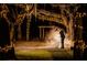 Couple embracing under a canopy of trees with lights at 15625 State Road 62 St, Parrish, FL 34219