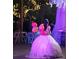 Young Personal in a quinceañera dress holding balloons at 15625 State Road 62 St, Parrish, FL 34219