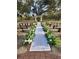 Outdoor wedding ceremony space with white floral arch and aisle at 15625 State Road 62 St, Parrish, FL 34219