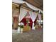 Wedding reception area with gold tablecloths and a red backdrop at 15625 State Road 62 St, Parrish, FL 34219