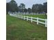 White vinyl fence borders a grassy pasture at 15625 State Road 62 St, Parrish, FL 34219