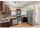 Modern kitchen with stainless steel appliances and dark cabinets at 4252 12Th N Ave, St Petersburg, FL 33713